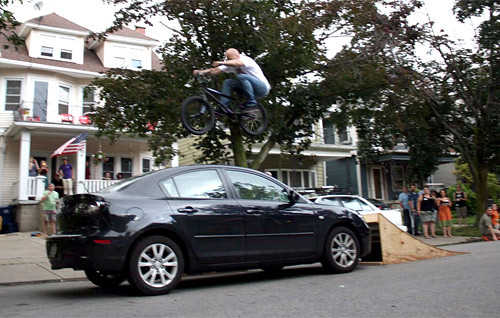 Jim Cielencki - Jumping over his car.
