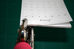 Punching the holes through the calendar's pages and stand