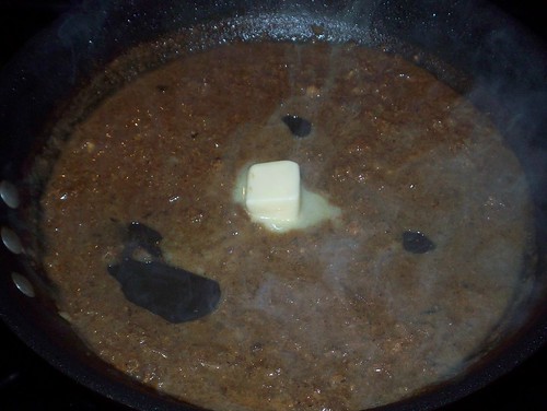 adding butter to whiskey mustard sauce
