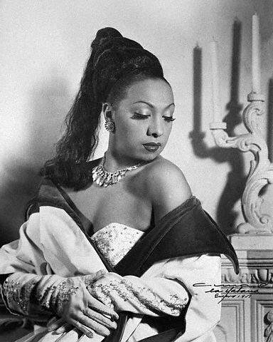 Josephine Baker, Sexy Bananas. Original caption: Exotic Josephine Baker, shown wearing one of her gorgeous gowns and opera gloves, part of her $150000