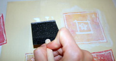 Applying the glue to the canvas and on top of the cut-out