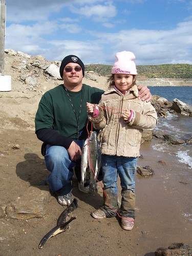 Father and daughter show off the day's catch at Diamond Lake near Hemet, California