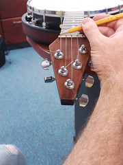 It was time to adjust the depth of the five notches in the nut.  One string at a time we strummed the string and tapped the string against the zero fret.