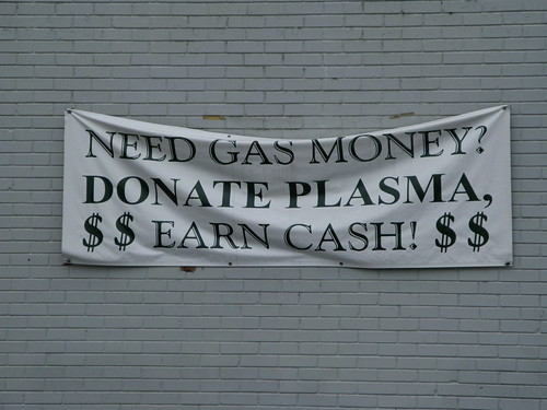 Sign on building: Need Gas Money? Donate Plasma. $$ Earn Cash $$