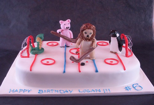 Animals playing hockey cake