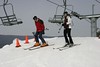 Two skiers get off a chair lift at Bryce Resort, Virginia