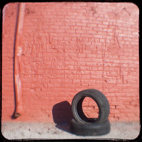 tire-against-red-brick