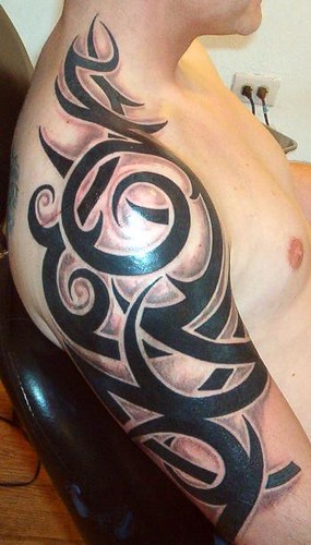 Creative Tribal Tattoos Design in Strong Man Arm