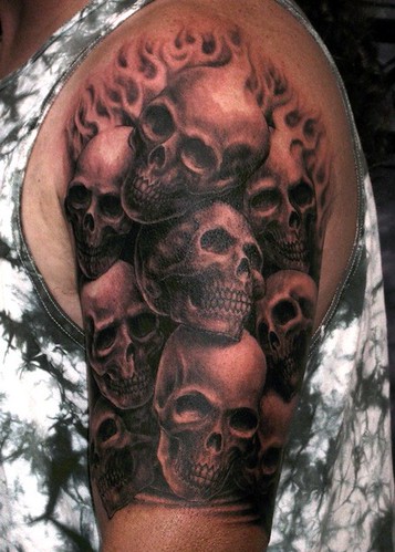 Pile of skulls tattoo black and gray tattoo by Matthew Amey