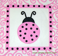 pink and black ladybug themed baby shower cake top view