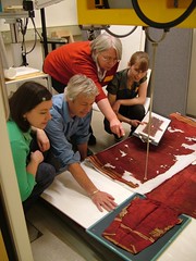 X-raying the tunic. From left: Elizabeth-Anne Haldane, Paul Robins (V&A), Dr. Sonia O'Conner (Bradford University) and Sara Gillies.