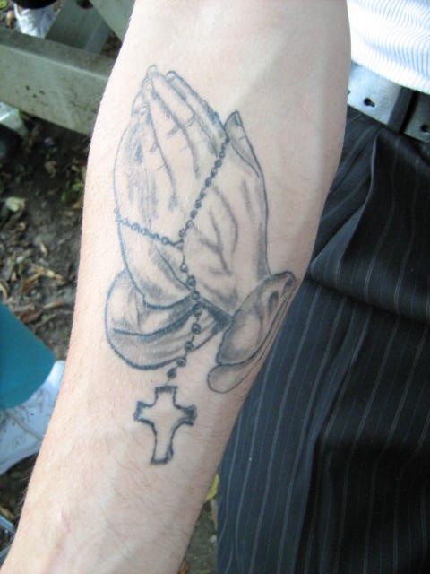 Preyer Hands holding Rosery. My cousins Tim's tattoo