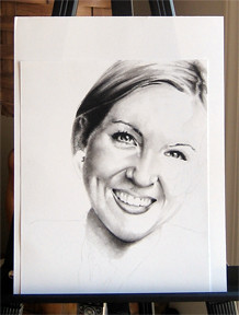 In progress photo of carbon pencil drawing entitled Ashley.