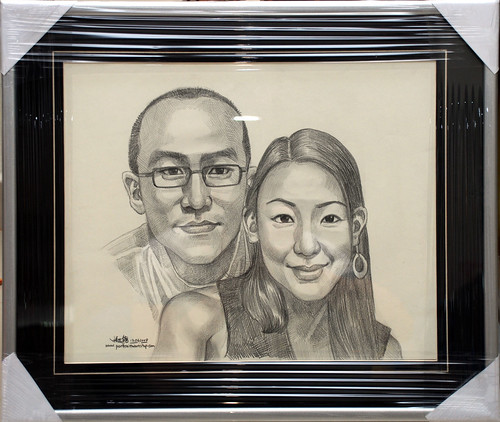 Couple portraits in pencil with matt silver frame and v-grrove border
