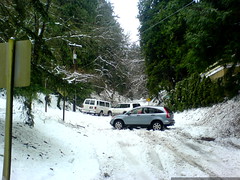 vehicles in various states of distress - two stuck and one abandoned - at the turn-off to our house - DSC02243