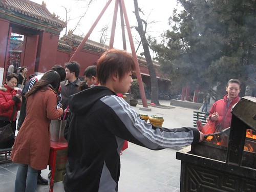 Beijing Lama Temple - People lighting incense sticks 
