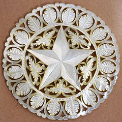 A 2 1/2-inch, hand-carved mother-of-pearl Bethlehem star button.