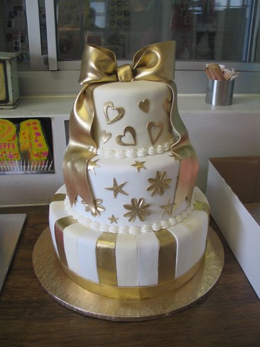 Gold  white fondant wedding cake with gold bow