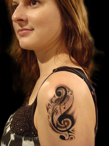 Musics Tribal Tattoo Design on Woman Arm 