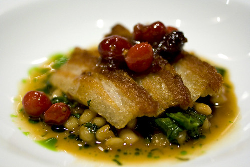 Close up of the Pork belly with coco beans, oloroso sherry and cranberries