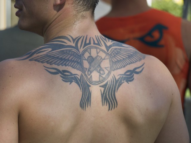 Tribal Wings and Crossed Fingers Tattoo
