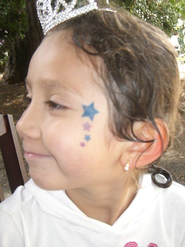 Star tattoo on the face of a child's cheek made permanently