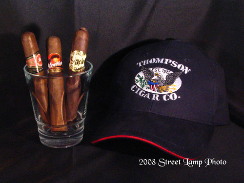 Three cigars and Thompson logo cap