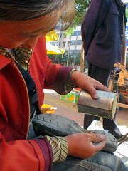 Keen Sandals get new rubber on sole in Huini, Gansu Province, China