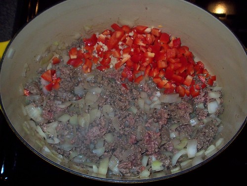 adding pepper and garlic to beef base