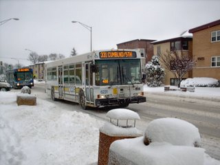 Two westbound Pace buses on Grand Avenue after a heavy overnight snowstorm. River Grove Illinois. January 2008.