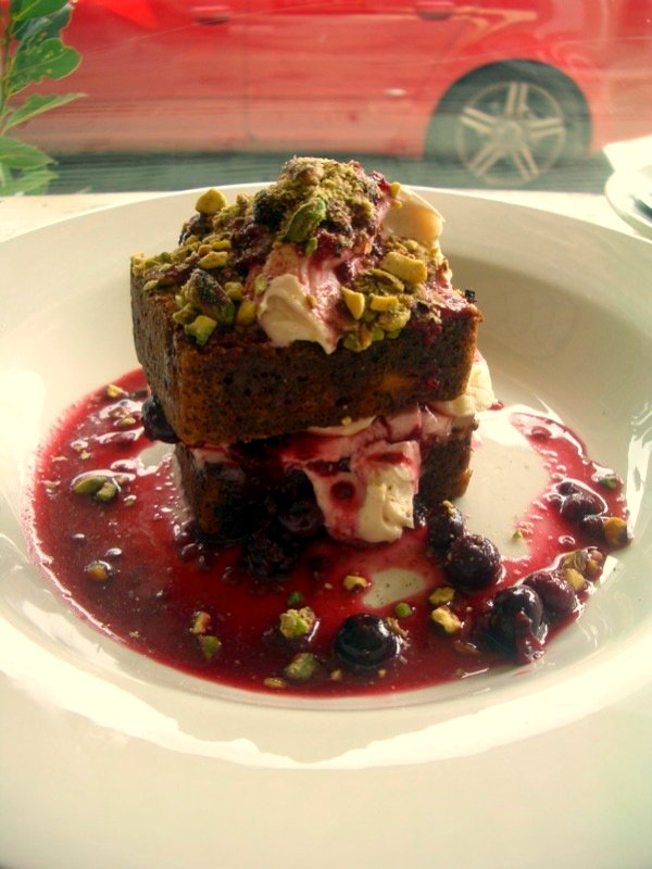 Toasted banana bread with maple syrup mascarpone, fresh banana, berry compote and crushed pistachio