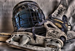Hockey skate, helmet, and sticks