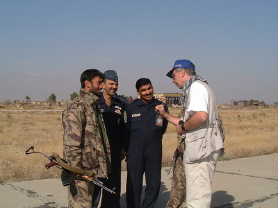 Peter negotiating with an Indian air crew and a Northern Alliance soldier in Afghanistan (2001)