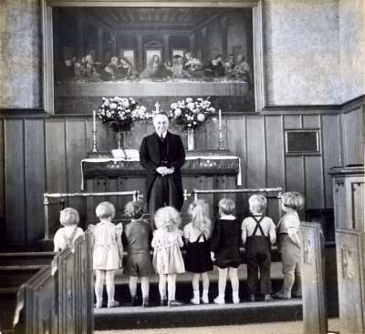 Children in the nave with a former pastor