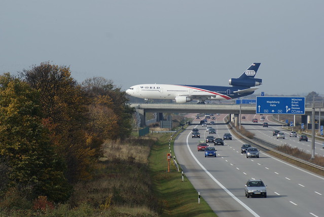 Airplane over road cars Leipzig