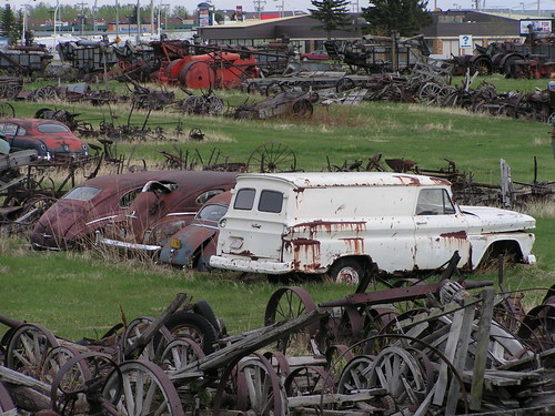 Old rusty cars and agricultural equipment
