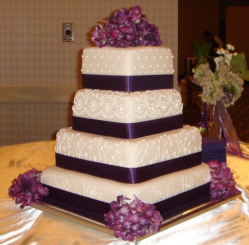 Square custom fondant wedding cake with scroll work purple ribbon and 