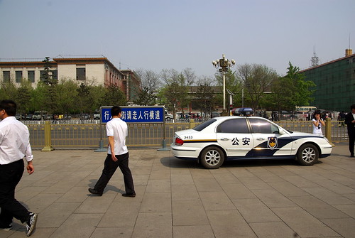 Tourists and police car on Tian'anmen Square