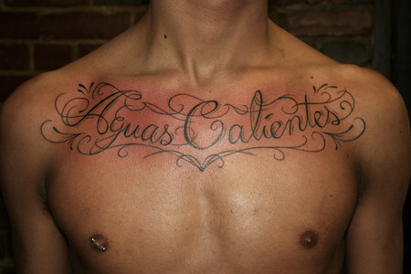 chest script writing tattoos