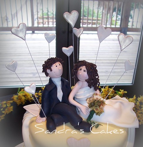 This handmade wedding cake topper was created to resemble the happy couple