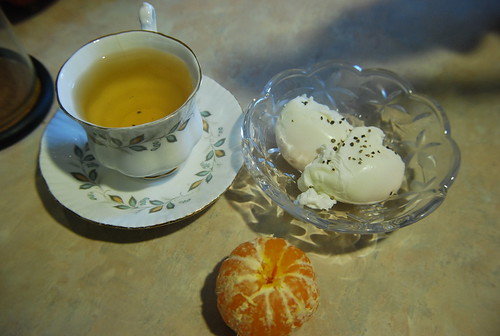 Poached eggs, orange, tea