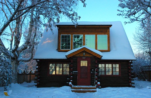 Fresh snow and log house