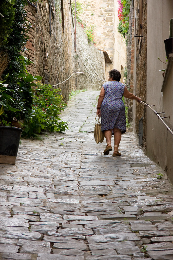 tuscany: lady walking up the street