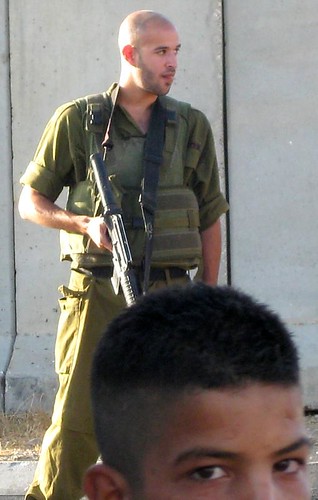 Atara - Bir Zeit checkpoint 12 July 2009 - child waiting in front of soldier with cocked gun