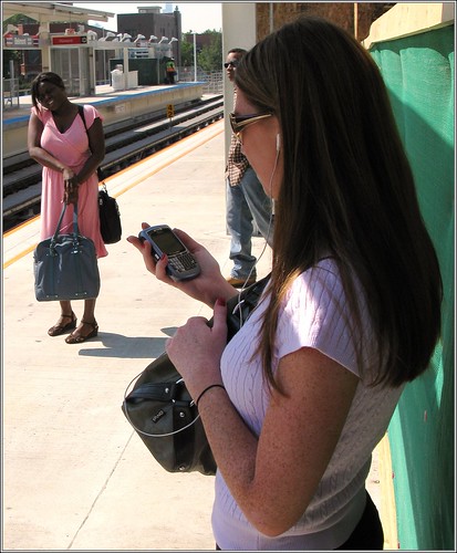 Photo of woman checking her smart phone for business listings