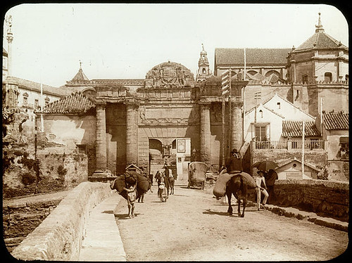 Lestrange. General view taken from a bridge at the entrance of the city. Door, characters, donkeys, church in the background.