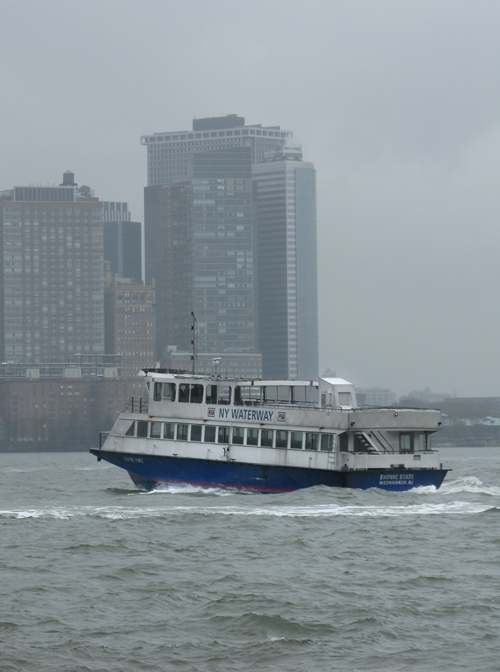 NY WATERWAY ferry on the rainy Hudson River with lower Manhattan, NYC