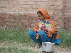 Naseemwith her books and a pot to fetch water