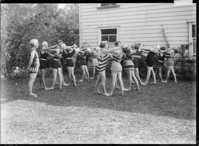 Group of girls practicing a life-saving technique. ca 1910s