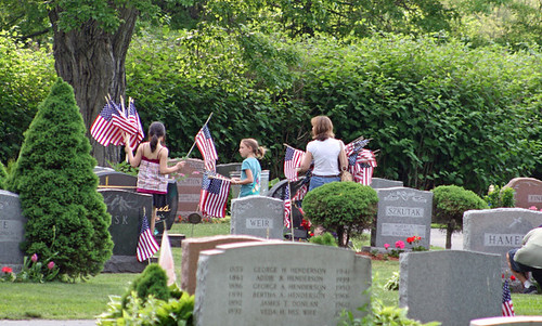 Placing flags at the graves of veterans